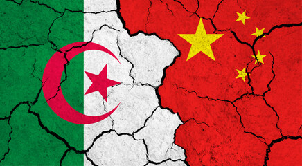 Flags of Algeria and China on cracked surface - politics, relationship concept