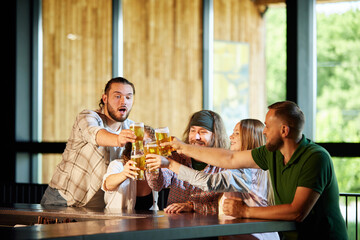 Young people, friends emotionally watching sport match online game, drinking beer, cheering up favourite sport team. Concept of sport competition, hobby, lifestyle, human emotions, fun