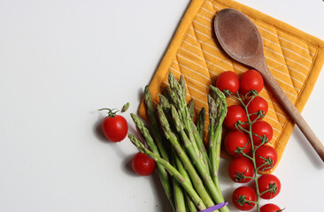 Still life with fresh seasonal vegetables on a table. Eating healthy concept. Organic asparagus close up photo. 