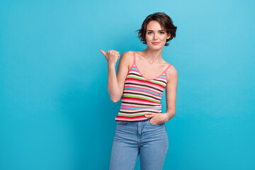Fototapeta na wymiar Photo of serious confident satisfied young girl pointing finger copyspace proposition store promo deal ad isolated on blue color background