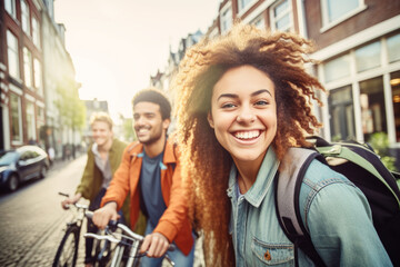 Happy group of young mix race people with backpack riding a bike in Amsterdam. Life style concept with friends having fun together on summer holiday