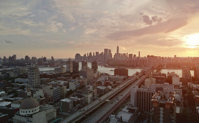 During sunset is panoramic view visible Manhattan across East River crossed by Williamsburg Bridge in New York city