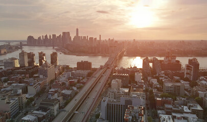 During sunset, New York City Manhattan skyline, visible across East River, is magnificently framed...