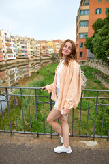 Tourist beautiful woman in Girona, Catalonia, Spain near of Barcelona. Famous resort destination in Costa Brava. Portrait of sexy woman posing at the town. Beautiful girl on the empty street in old