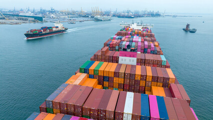 Stern of large cargo container ship import export container box on the ocean sea on blue sky back...