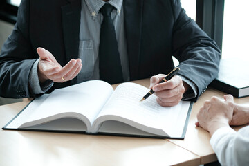 Legal counsel presents to the client a signed contract with gavel and legal law. justice and lawyer concept.