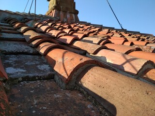 Pattern of old terracotta tile roof under Florentine sun. Detail of orange tile roof. Campanile of Florence Cathedral, Florence, Tuscany, Italy, Europe