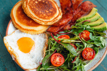 Breakfast Pancakes with Fried Eggs, Bacon and Mixed Salad