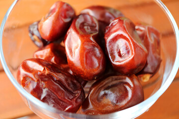Closeup of Heap of Dried Dates in a Glass Compote Bowl