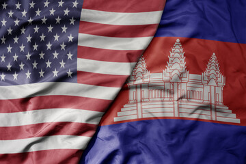 big waving colorful flag of united states of america and national flag of cambodia .
