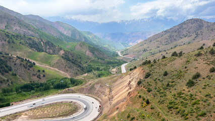 Fototapeta na wymiar Automobile road among the picturesque mountain valley