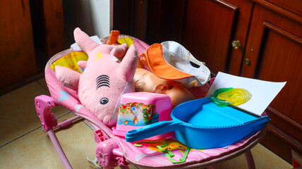 Piles of various children's toys such as dolls, sharks and sand containers in