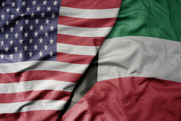 big waving colorful flag of united states of america and national flag of kuwait .
