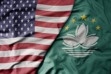 big waving colorful flag of united states of america and national flag of Macau .