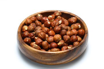 Wooden bowl full of hazelnuts on white background. Healthy eating concept. Super foods.