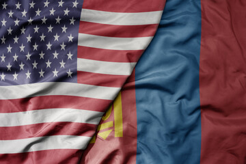 big waving colorful flag of united states of america and national flag of mongolia .