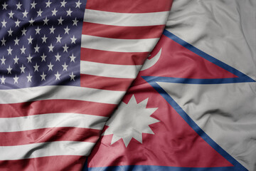 big waving colorful flag of united states of america and national flag of nepal .