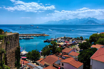 View to sea and mountains from historic old town of Kaleici Antalya Turkey with boats and harbour...