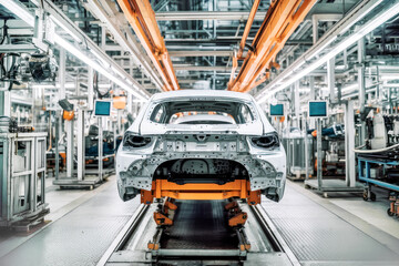 Assembly of an electric vehicle in a modern and technologically advanced automotive plant using cutting-edge manufacturing processes. The concept of green transportation