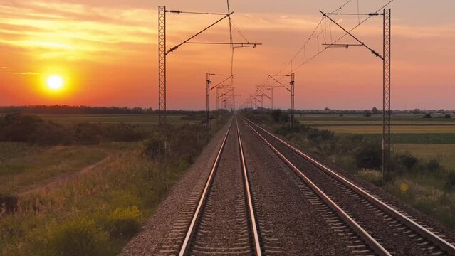Railway track with electric powerline poles, motion footage.