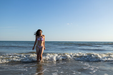 Fototapeta na wymiar Beautiful brunette woman wearing swimsuit in sea have fun