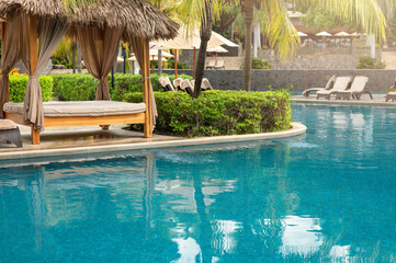 Spa cabana next to blue pool