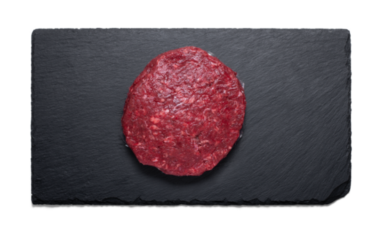 Raw beef maxi burger on a slate plate from above with a semitransparent shadow - Powered by Adobe