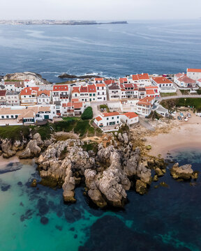 Aerial view of Praia dos Barcos, a small inlet with beach along the coastline in Baleal, a small town on island in Leiria, Portugal.