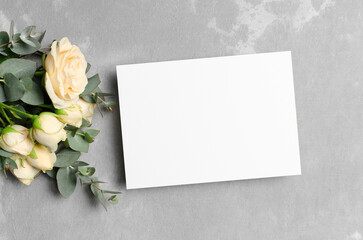 Obraz na płótnie Canvas Wedding invitation or greeting card mockup with roses flowers on grey background