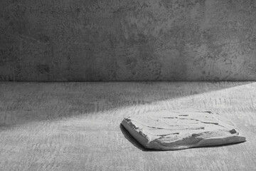 Black and white stone podium display, gray mockup background. Decorative textured stand for beauty...