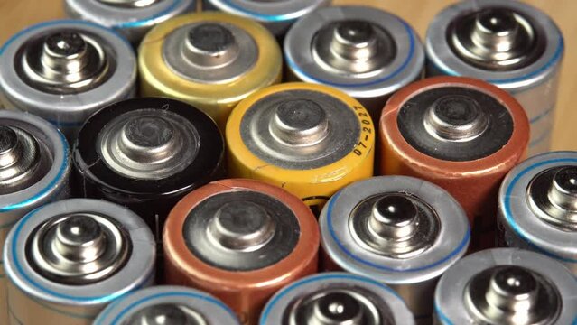 Rows of used alkaline AA batteries. Lithium ion battery pack close up. Electric power supply for electric vehicle EV. Environmental pollution, non-recyclable waste, green energy