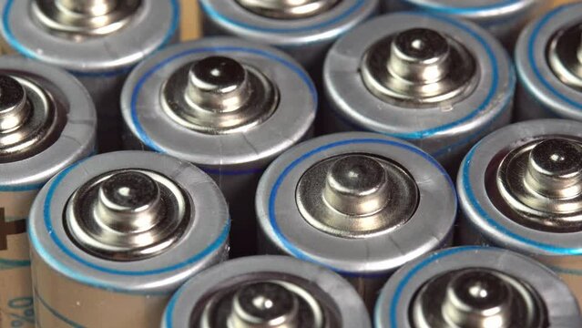 Rows of used alkaline AA batteries. Lithium ion battery pack close up. Electric power supply for electric vehicle EV. Environmental pollution, non-recyclable waste, green energy