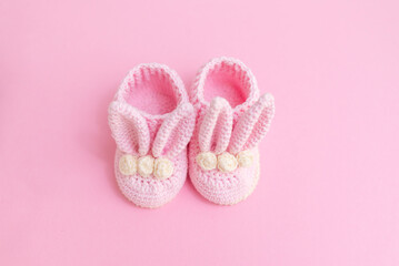 Cute wooden baby toys on a pink background. Eco accessories and teethers for newborns. Blank space for text. Flat plan, top view