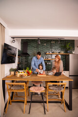 Young family preparing vegetables in the kitchen