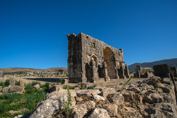 Fototapeta na wymiar Volubilis ruins, a partly-excavated Berber-Roman city that may have been the capital of the Kingdom of Mauretania, situated near the city of Meknes, Morocco