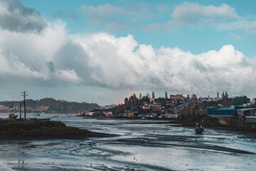 boat in low tide by the sea shore