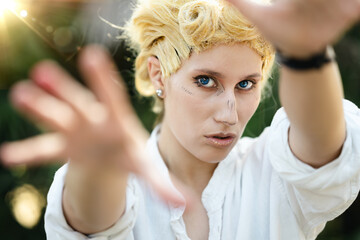 Italian girl cosplay Giorno Giovanna from the anime jojo. Blond woman with blue eyes. Close up to...