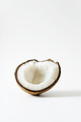 Half of a fresh cracked coconut on a white background