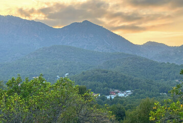 Mountains landscape on sunset. Mountain view from Mola De Segart mountain in Sierra Calderona national park in Valencia, Spain. House in mountains. Landscape of a mountain valley with houses.