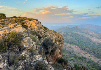 Mountains landscape on sunset. Mountain view from Mola De Segart mountain in Sierra Calderona national park in Valencia, Spain. Sunset over mountains. Landscape of a mountain valley. Hill on sunrise.