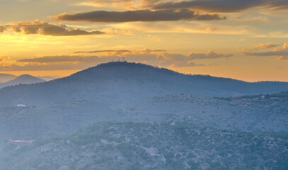 Mountains landscape on sunset. Mountain view from Mola De Segart mountain in Sierra Calderona national park in Valencia, Spain. Sunset over mountains. Landscape of a mountain valley. Hill on sunrise.