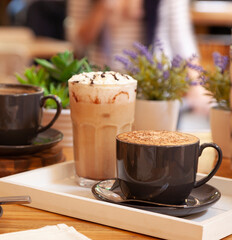 Coffee with milk and cocoa with chocolate syrup and cream.