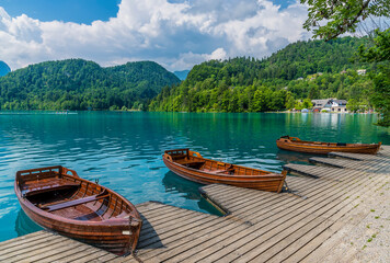 A view past boats along the shore of Lake Bled in Bled, Slovenia in summertime