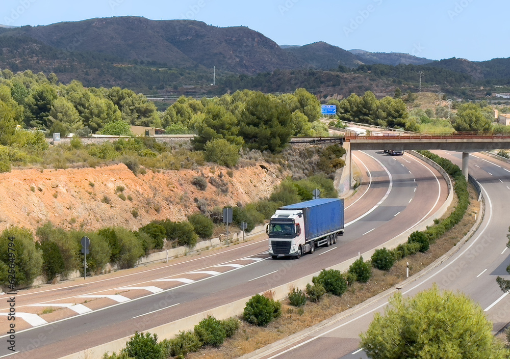 Wall mural semi truck with semi-trailer driving along highway. goods delivery by roads. services and transport 