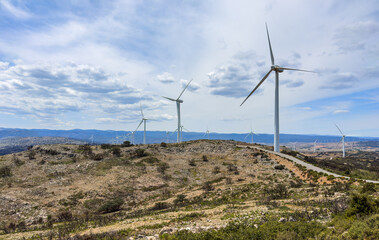 Wind turbine in mountains landscape. Eolic park windpower. Wind farm or New Wind green energy. Wind turbines alternative energy. Windmill power clean electricity generation in Valencia. Spain Windfarm