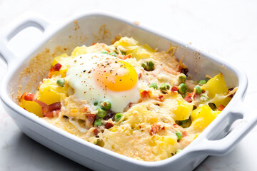 potatoes baked with smoked meat, green peas and cheddar cheese served with fired egg