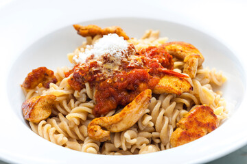 pasta fusilli with spicy chicken meat and tomato sauce