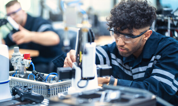 Mechanical engineering team working in robotic technology lap for research and develop for manufacturing automation and robotics.