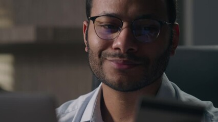 Close up joyful happy man office worker in glasses shopping online with computer businessman with laptop and credit card paying in internet bank booking order delivery buying easy payment purchase app