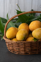 Fresh and healthy mango fruit in the basket with leaves, National mango day image